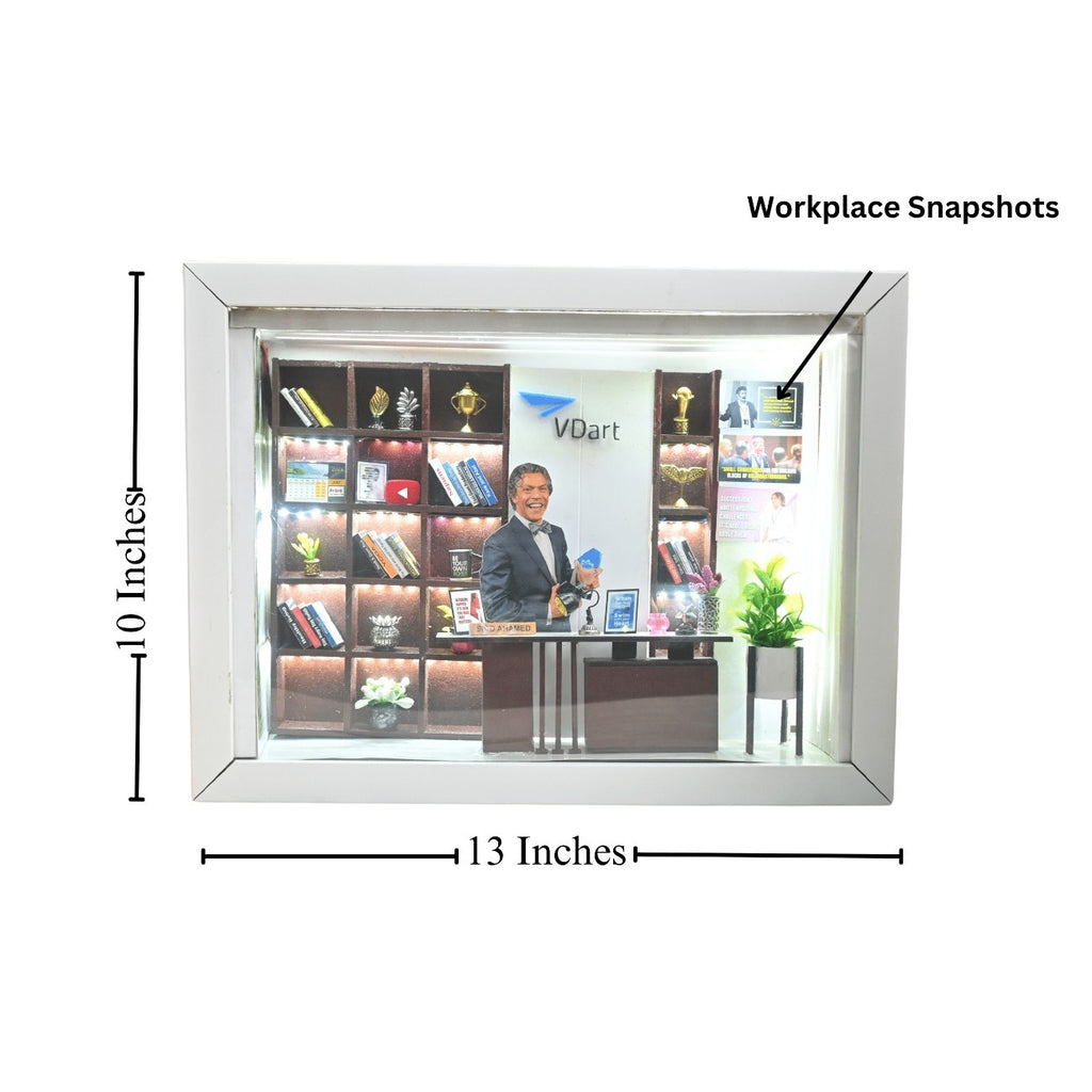 A framed photo of a person in a suit at a modern office desk, with a background of shelves displaying books and awards. Frame dimensions: 13x10 inches.