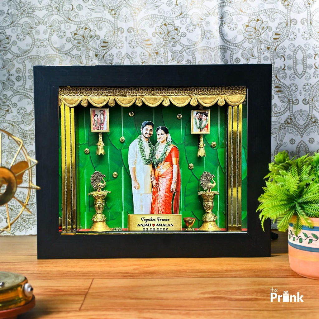 Shadow box displaying a couple in traditional Indian attire, set against a green and gold backdrop with decorative elements. Text reads "Together Forever."