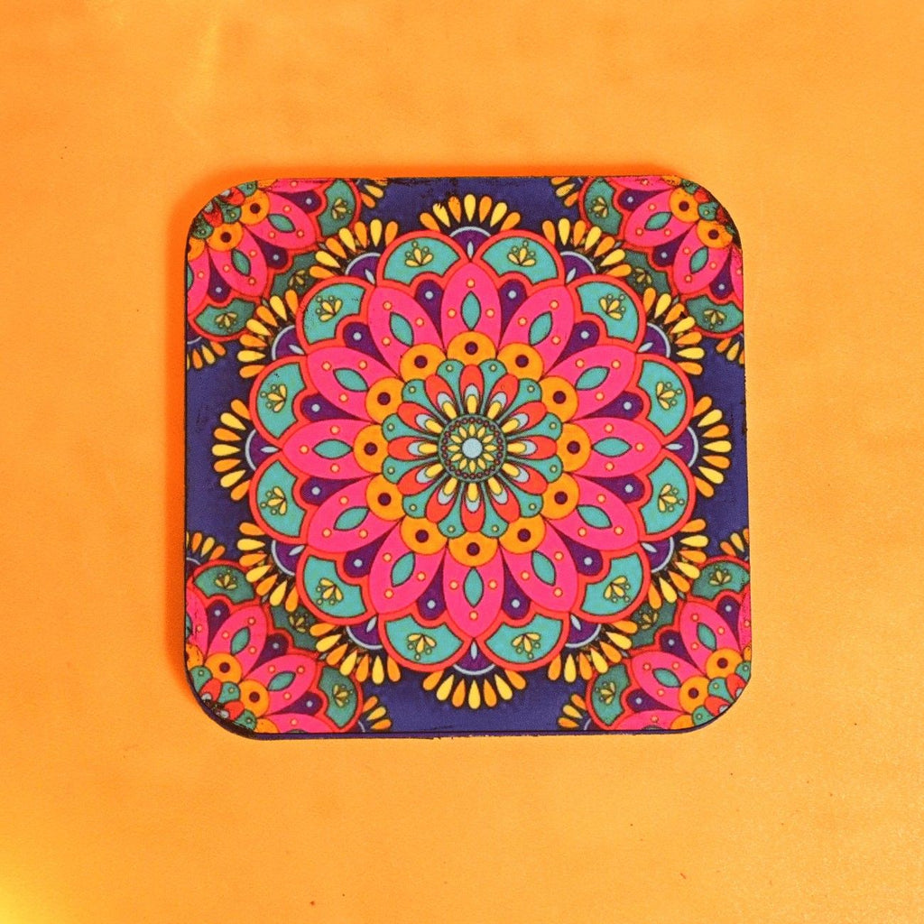 A vibrant, colorful coaster features an intricate mandala design with blue, pink, and yellow patterns on an orange background, conveying a cheerful tone.