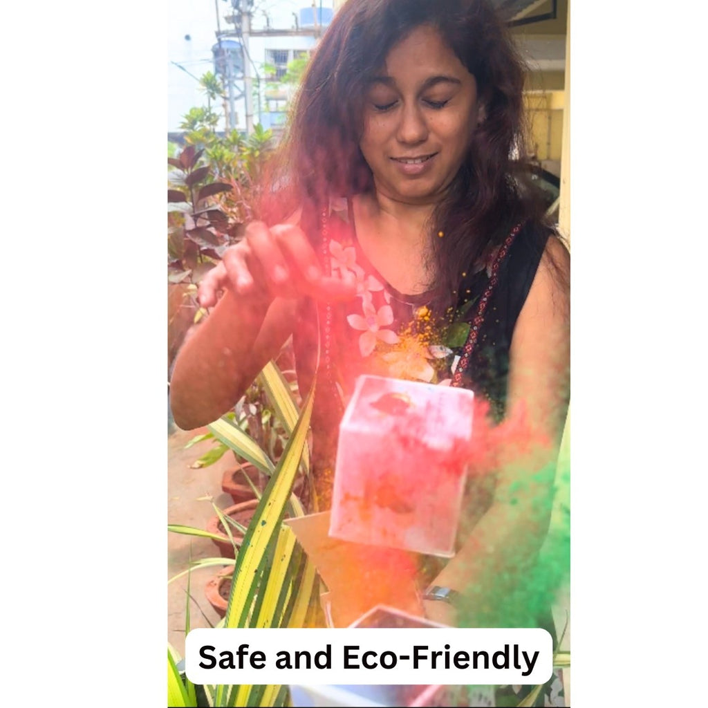 A woman on a balcony opens a colorful box, releasing vibrant pink powder and cubes into the air. Her expression is joyful.