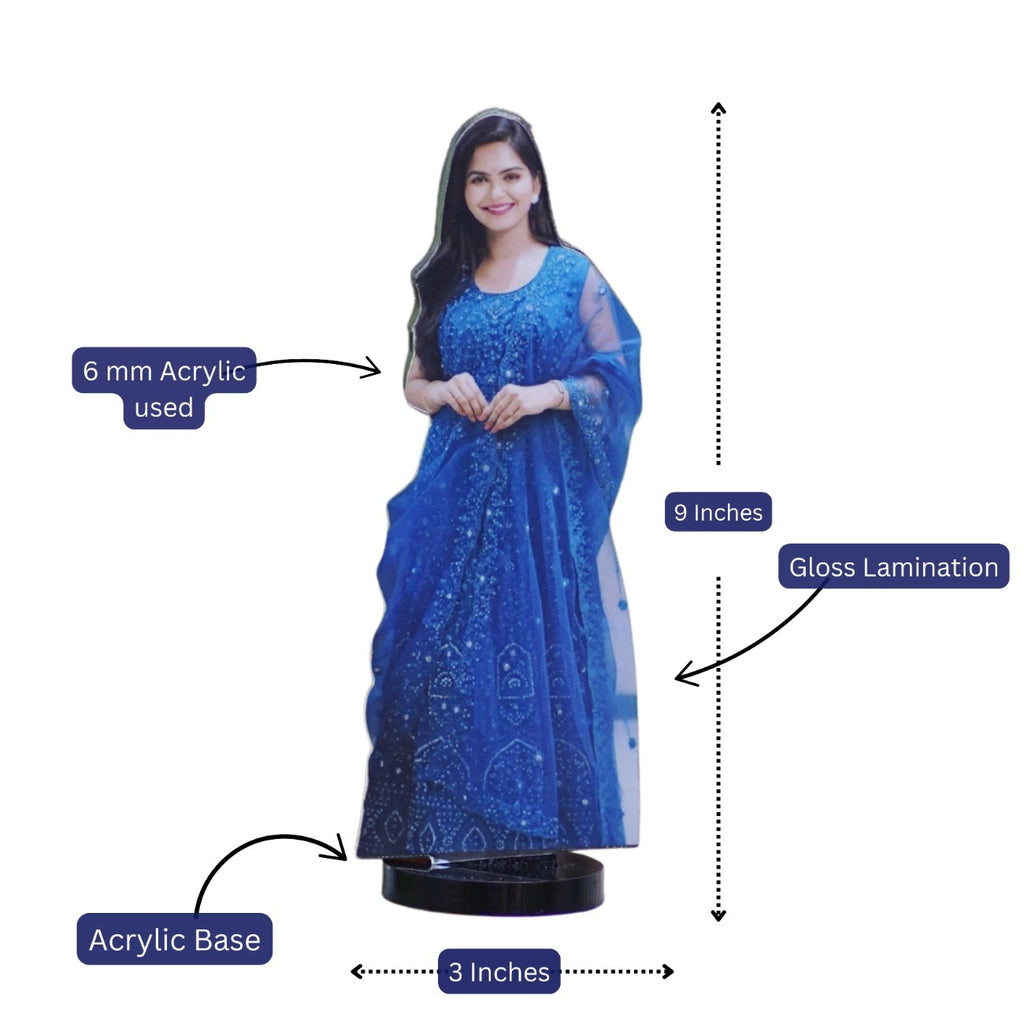 A wooden cutout of a smiling woman in a blue dress with intricate patterns, standing on a 3-inch acrylic base. Cutout measures 9 inches tall with gloss lamination.