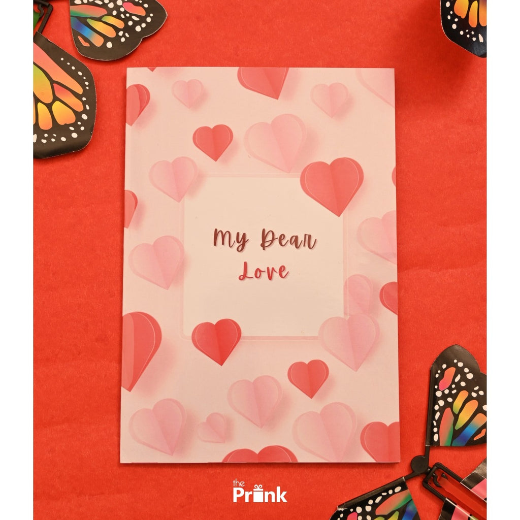 A romantic card on a red background reads "My Dear Love" with a pink and red heart pattern. Colorful butterfly cutouts frame the corners, adding a whimsical touch.