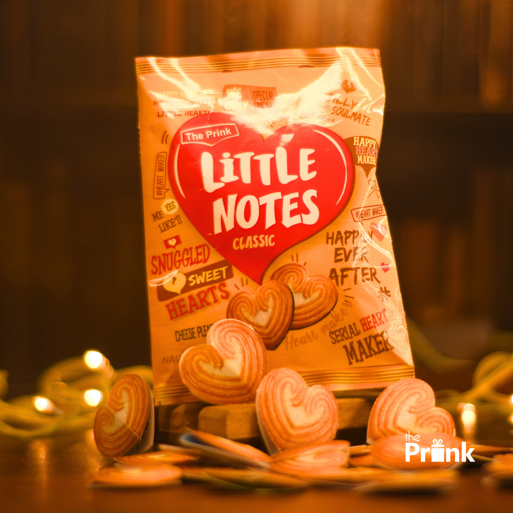 Bag of "Little Notes Classic" heart-shaped notes on a wooden table. Warm ambient lights create a cozy atmosphere, highlighting the sweet bond.