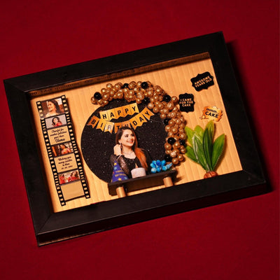 Framed birthday collage with gold and black accents features balloons, a photo of a smiling woman, filmstrip-like decorations, and festive text.