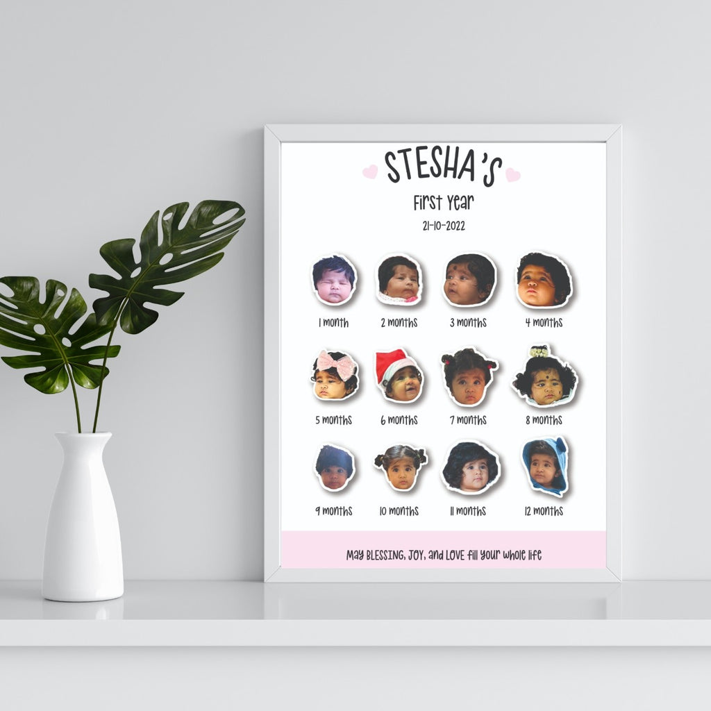 Framed poster titled "Stesha's First Year" displaying 12 monthly baby photos. It's placed on a shelf beside a white vase with green leaves.