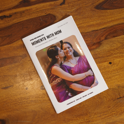 Personalized photo magazine with a glossy cover featuring a mother and daughter, placed on a soft beige gradient background with minimal, high-end styling.