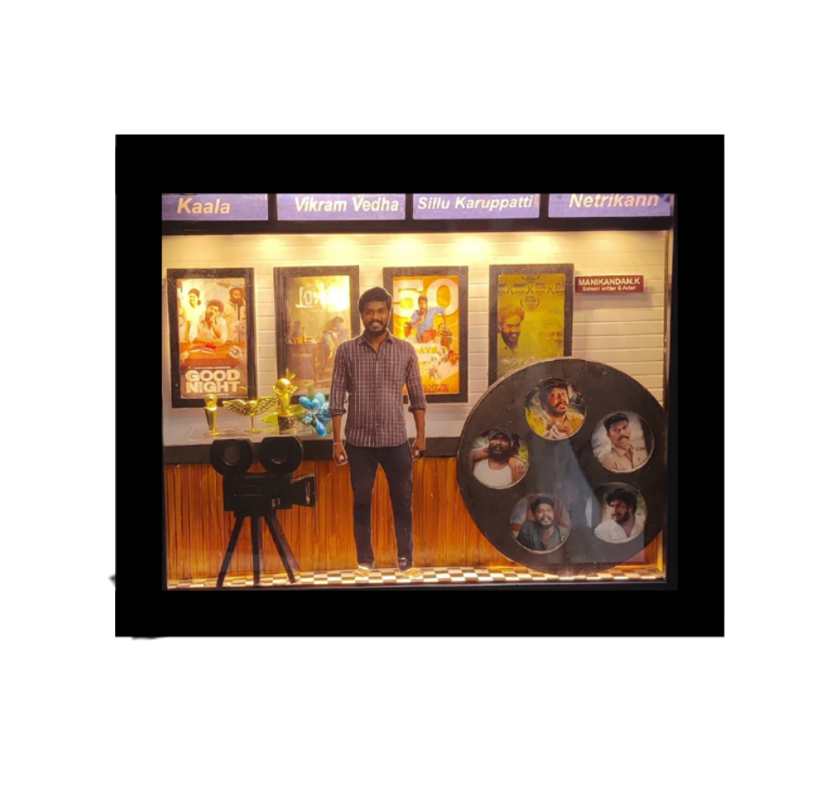 movie-themed miniature – With camera cut-outs, director's clapboard, movie reels, posters of favorite films, and a photo in the center like a film still.
