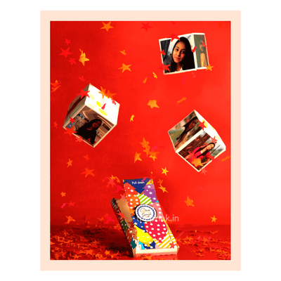 Colorful gift cubes with photos float against a bright red background, surrounded by playful star-shaped confetti, creating a joyful, celebratory mood.